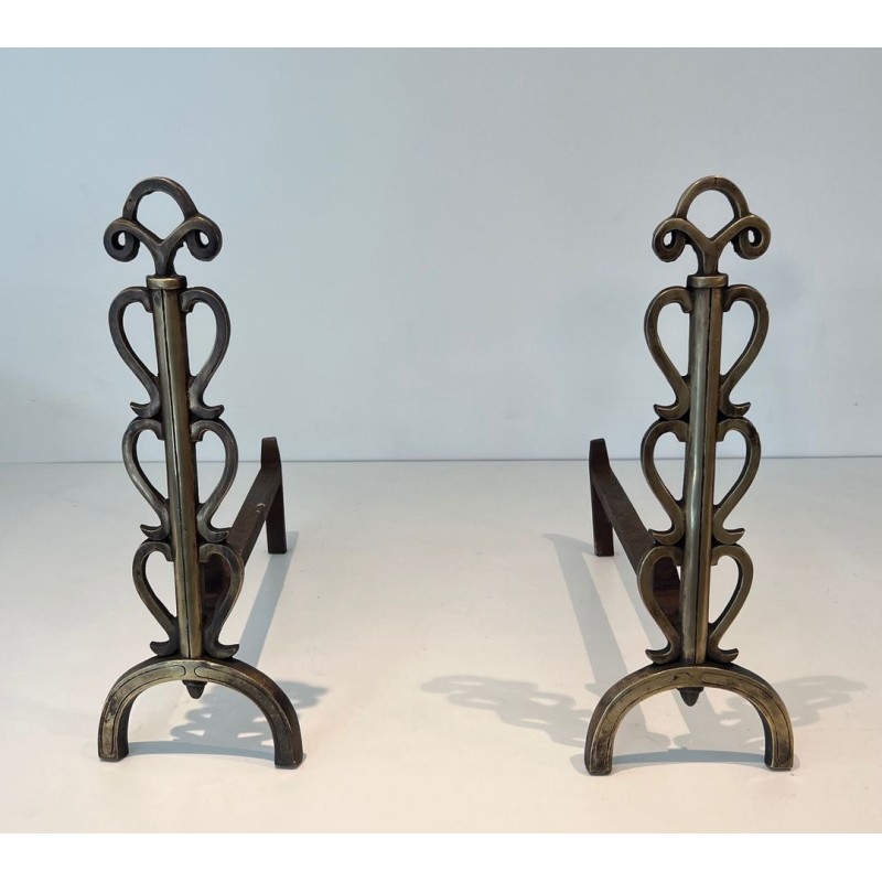 Pair of Brass and Iron Andirons with Stacked Scroll-Column Uprights on Arched Bases, in the Style of Raymond Subes