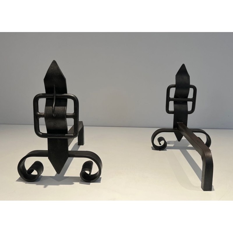 Pair of Wrought Iron Andirons with Obelisk Finials and Belt-and-Buckle Motifs on Scrolled Bases