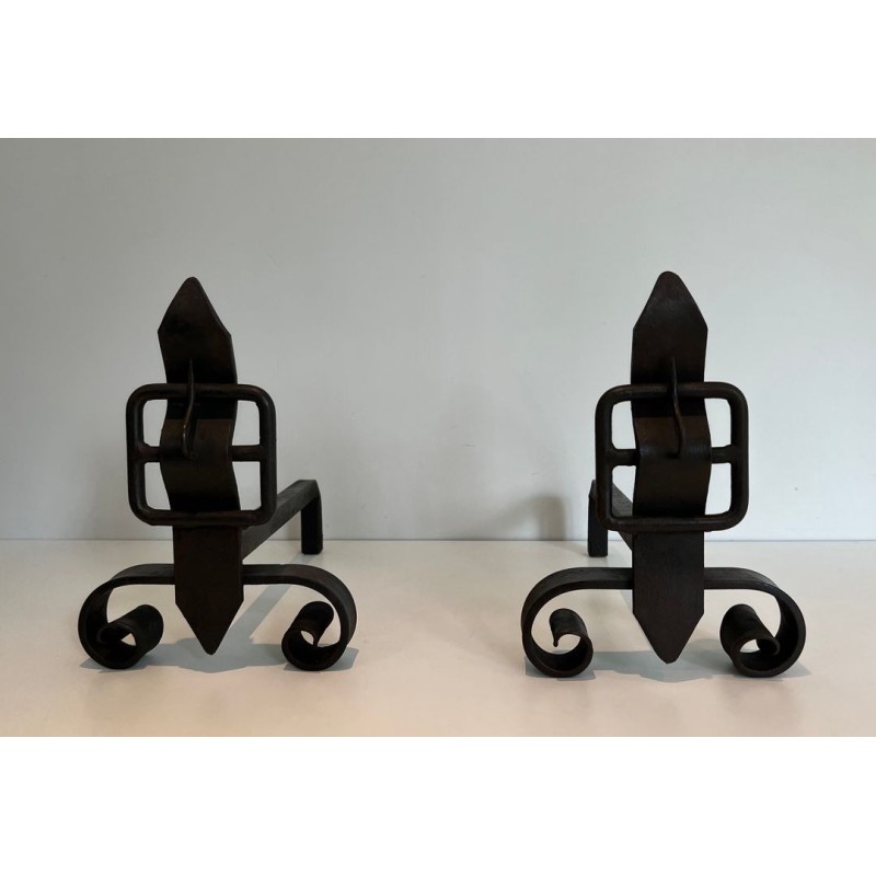 Pair of Wrought Iron Andirons with Flame Finials and Strap-Buckle Midsection. France. Circa 1950.