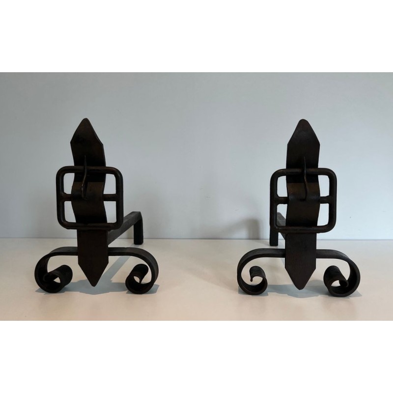 Pair of Wrought Iron Andirons with Flame Finials and Strap-Buckle Midsection. France. Circa 1950.