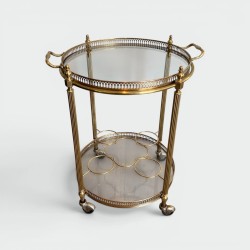 Round Bar Cart in Brass with Two Glass Tops and Bottle Holder, in the Style of Maison Jansen, French Work, 1940s.
