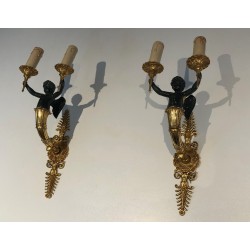 Pair of Empire Style Sconces with Two Light Arms in Gilt and Patinated Bronze Depicting a Winged Cupid, 19th Century