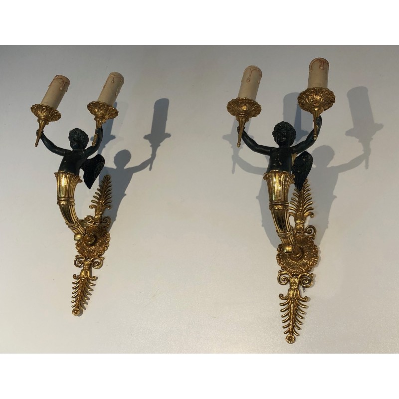 Pair of Empire Style Sconces with Two Light Arms in Gilt and Patinated Bronze Depicting a Winged Cupid, 19th Century