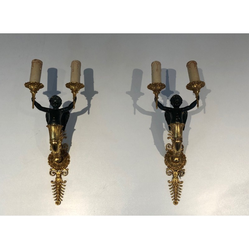 Pair of Empire Style Sconces with Two Light Arms in Gilt and Patinated Bronze Depicting a Winged Cupid, 19th Century