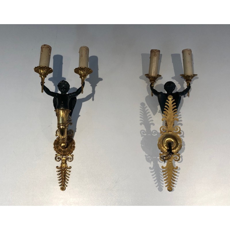 Pair of Empire Style Sconces with Two Light Arms in Gilt and Patinated Bronze Depicting a Winged Cupid, 19th Century