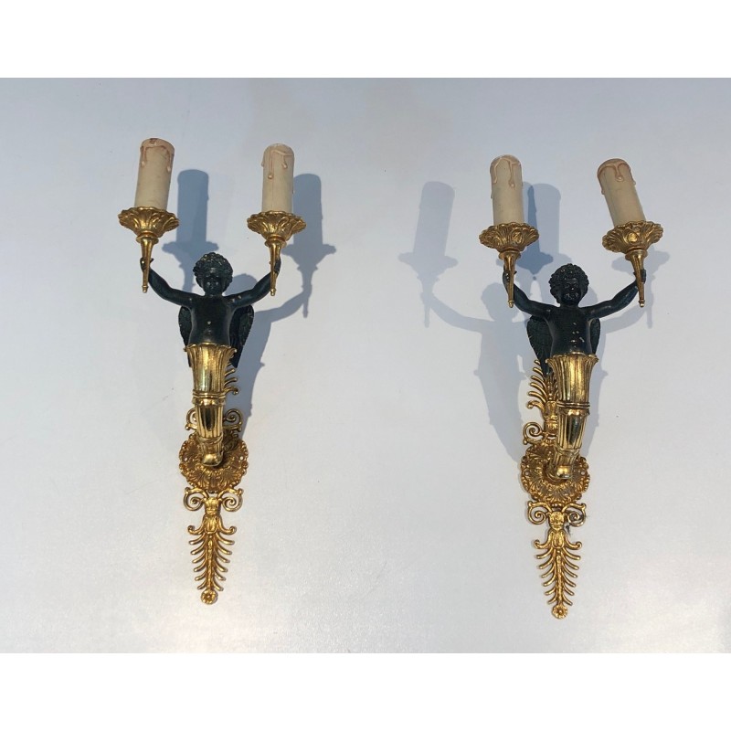 Pair of Empire Style Sconces with Two Light Arms in Gilt and Patinated Bronze Depicting a Winged Cupid, 19th Century
